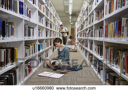 Young students in a library View Large Photo Image Stock Image - Young students in a library. Fotosearch