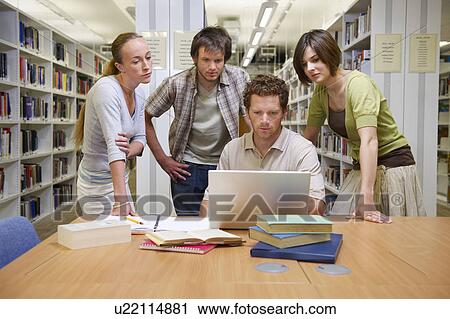 Young students in a library View Large Photo Image Stock Image - Young students in a library. Fotosearch