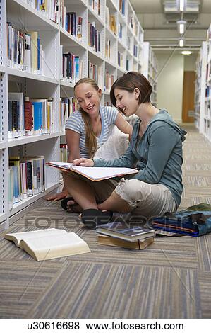 Young students in a library View Large Photo Image Stock Photo - Young students in a library. Fotosearch