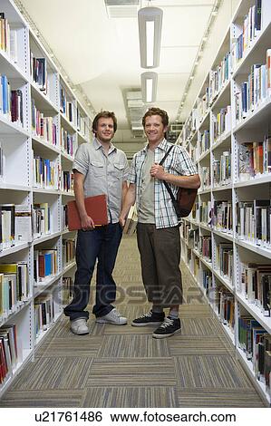 Young students in a library View Large Photo Image Stock Photograph - Young students in a library. Fotosearch