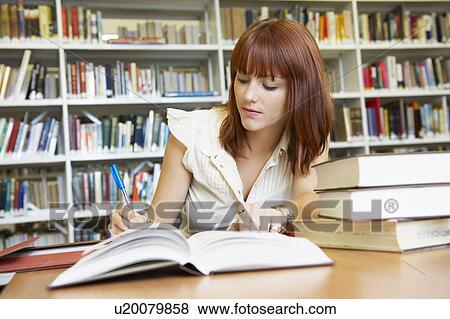 Young woman working in library View Large Photo Image Stock Photo - Young woman working in library. Fotosearch