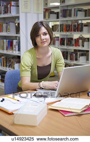 Young woman working in library View Large Photo Image Stock Photography - Young woman working in library. Fotosearch