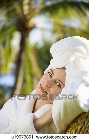 Caucasian mid-adult woman wearing robe with towel on head relaxing in tropical place. View Large Photo Image Stock Image - Caucasian mid-adult woman wearing robe with towel on head relaxing in tropical place.. Fotosearch