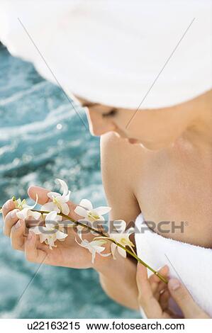 Pretty Caucasian mid-adult woman wearing towel on head holding flowers beside pool. View Large Photo Image Stock Photography - Pretty Caucasian mid-adult woman wearing towel on head holding flowers beside pool.. Fotosearch