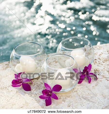 Three candles and three purple orchids by pool. View Large Photo Image Stock Image - Three candles and three purple orchids by pool.. Fotosearch
