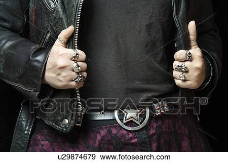 Stock Photo - Caucasian woman's hands with silver rings holding onto black leather jacket.. Fotosearch