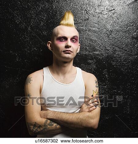 Stock Image - Male punk with his arms crossed. Fotosearch