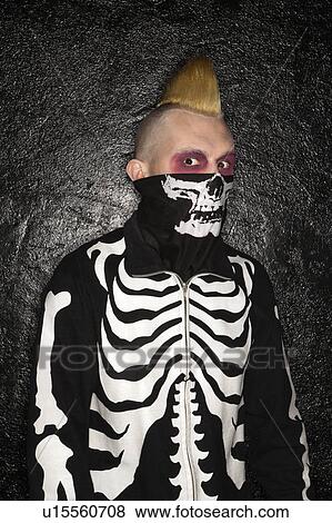 Stock Photo - Mid-adult Caucasian male punk wearing skeleton sweatshirt and skeleton bandanna.. Fotosearch