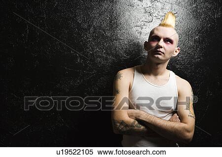 Stock Photography - Portrait of male punk rocker with crossed arms. Fotosearch