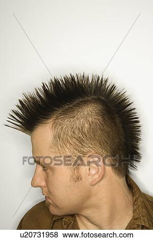 Stock Photo - Side view of Caucasian man with mohawk against white background.. Fotosearch