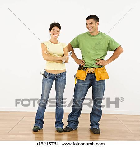 Picture - Couple with tools standing and smiling in home.. Fotosearch