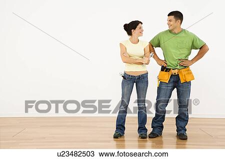 Couple with tools standing and smiling in home. View Large Photo Image Stock Image - Couple with tools standing and smiling in home.. Fotosearch