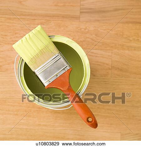 High angle view of paintbrush resting on paint can on wood floor View Large Photo Image Stock Photo - High angle view of paintbrush resting on paint can on wood floor. Fotosearch