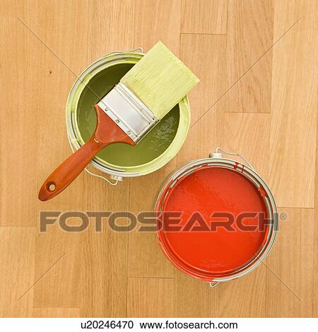 Stock Image - Paintbrush with paint cans on wood floor. Fotosearch