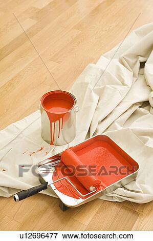 Stock Photo - Painting supplies on drop cloth on wood floor.. Fotosearch