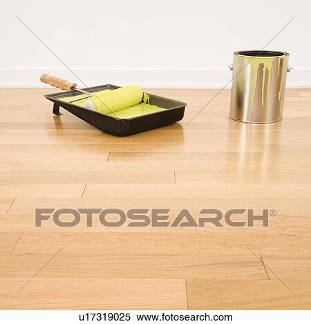Still life of paint roller in tray with paint can on wood floor. View Large Photo Image Stock Photography - Still life of paint roller in tray with paint can on wood floor.. Fotosearch