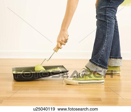 Woman dipping paint roller in tray of paint View Large Photo Image Stock Photo - Woman dipping paint roller in tray of paint. Fotosearch