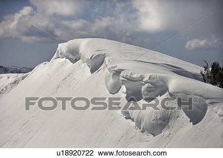 Stock Image - Aerial of snowcapped mountain peak in Crystal Mountains, California, USA.. Fotosearch