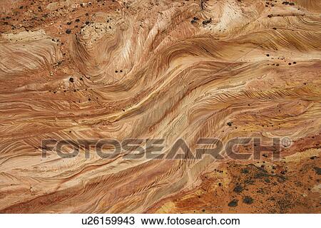 Stock Image - Aerial of textured red rock in desert of Arizona, USA. Fotosearch