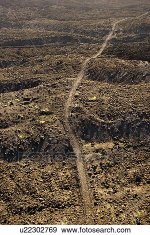 Aerial view of trail through lava rock filled terrain in Maui, Hawaii. View Large Photo Image Stock Photo - Aerial view of trail through lava rock filled terrain in Maui, Hawaii.. Fotosearch