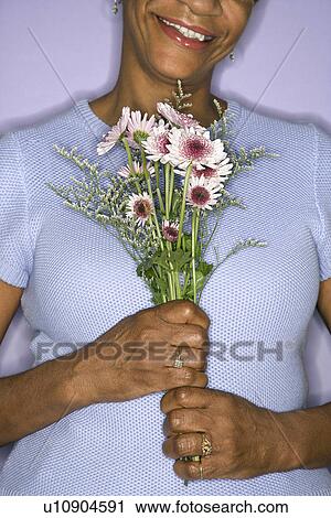 Female holding flowers View Large Photo Image Stock Image - Female holding flowers. Fotosearch