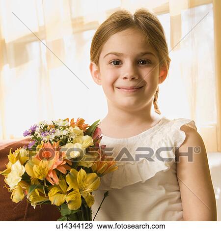 Girl smiling at viewer with bouquet of flowers View Large Photo Image Stock Photo - Girl smiling at viewer with bouquet of flowers. Fotosearch