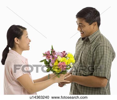 Giving a bouquet of flowers View Large Photo Image Stock Image - Giving a bouquet of flowers. Fotosearch