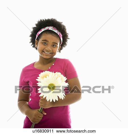 Stock Image - Holding large Gerbera Daisies smiling. Fotosearch