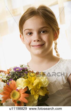 Smiling with bouquet of flowers View Large Photo Image Stock Photo - Smiling with bouquet of flowers. Fotosearch