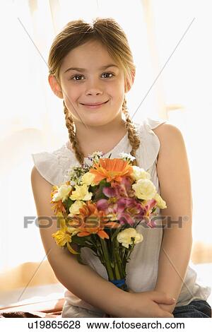 Stock Photo - Smiling with bouquet of flowers. Fotosearch