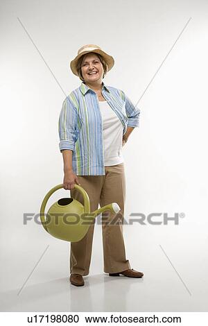 Woman holding watering can View Large Photo Image Stock Image - Woman holding watering can. Fotosearch
