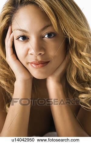 Stock Image - Head and shoulder portrait of pretty young woman.. Fotosearch