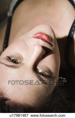 Sexy woman lying down looking up at viewer View Large Photo Image Stock Photo - Sexy woman lying down looking up at viewer. Fotosearch