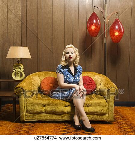Picture - Attractive Caucasian woman sitting in retro decorated room.. Fotosearch
