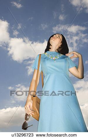 Caucasian young adult woman in retro clothing looking up at sky. View Large Photo Image Stock Image - Caucasian young adult woman in retro clothing looking up at sky.. Fotosearch