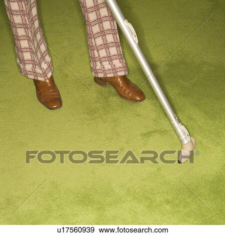 Close-up of Caucasian male feet with vacuum extension against green retro carpet. View Large Photo Image Stock Photo - Close-up of Caucasian male feet with vacuum extension against green retro carpet.. Fotosearch