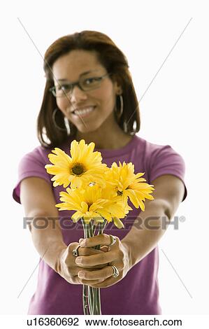 African American mid adult woman wearing glasses holding bouquet of flowers towards viewer. View Large Photo Image Stock Image - African American mid adult woman wearing glasses holding bouquet of flowers towards viewer.. Fotosearch
