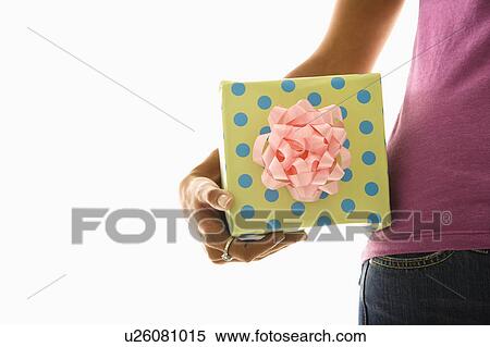 Arm and hips of African American woman holding wrapped package. View Large Photo Image Stock Photography - Arm and hips of African American woman holding wrapped package.. Fotosearch