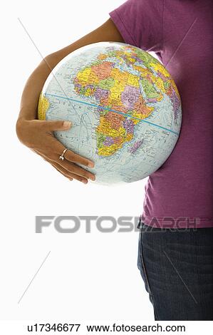 Arm and hips of woman holding globe View Large Photo Image Stock Photo - Arm and hips of woman holding globe. Fotosearch