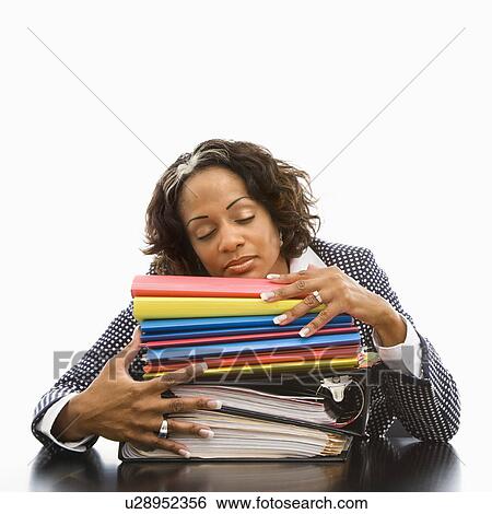 Businesswoman resting head on large stack of books and files with eyes closed View Large Photo Image Stock Photograph - Businesswoman resting head on large stack of books and files with eyes closed. Fotosearch