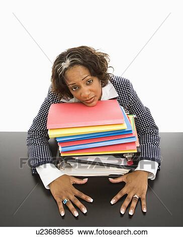 Businesswoman resting head on large stack of books and files. View Large Photo Image Stock Photography - Businesswoman resting head on large stack of books and files.. Fotosearch