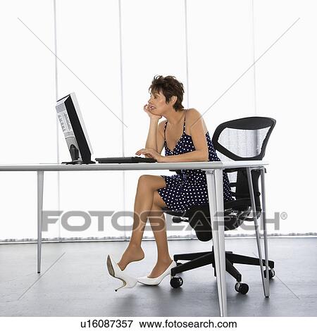 Caucasian businesswoman sitting at desk with computer in office. View Large Photo Image Stock Photo - Caucasian businesswoman sitting at desk with computer in office.. Fotosearch
