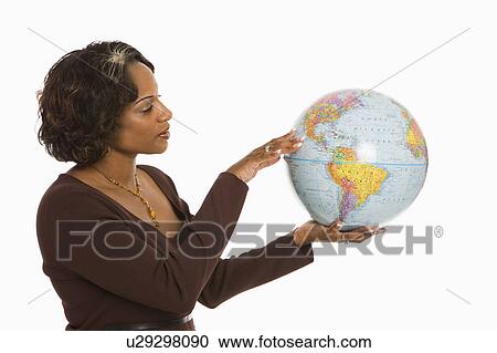 Stock Image - Woman holding world globe out between hands. Fotosearch