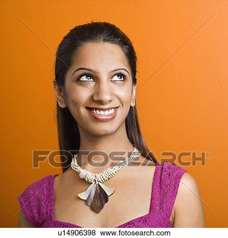 Stock Photo - Woman smiling at looking up. Fotosearch