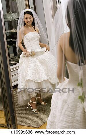 Asian bride admiring shoes in mirror. View Large Photo Image Stock Photograph - Asian bride admiring shoes in mirror.. Fotosearch