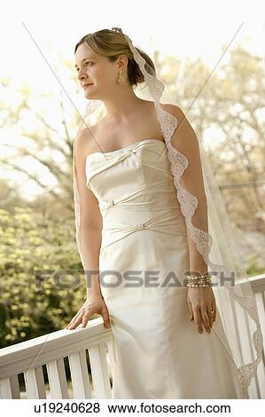 Stock Photo - Bride beside railing. Fotosearch