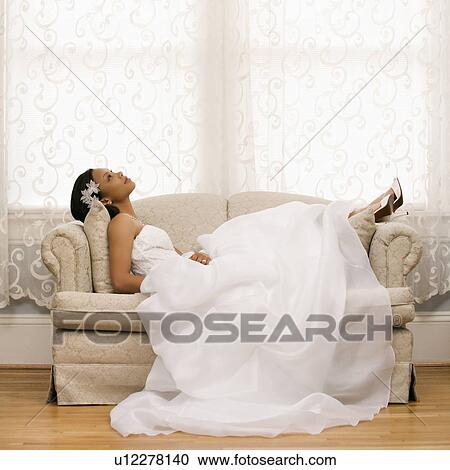 Bride lying on love seat View Large Photo Image Stock Image - Bride lying on love seat. Fotosearch
