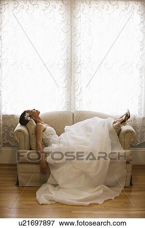 Bride lying on love seat View Large Photo Image Stock Photo - Bride lying on love seat. Fotosearch