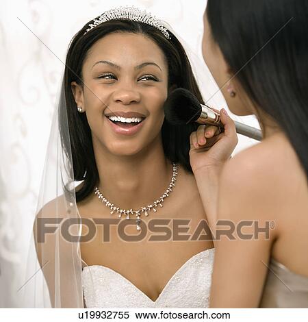 Bridesmaid applying makeup to bride View Large Photo Image Stock Photography - Bridesmaid applying makeup to bride. Fotosearch