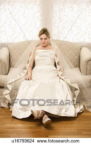 Picture - Caucasian bride slouching in love seat.. Fotosearch